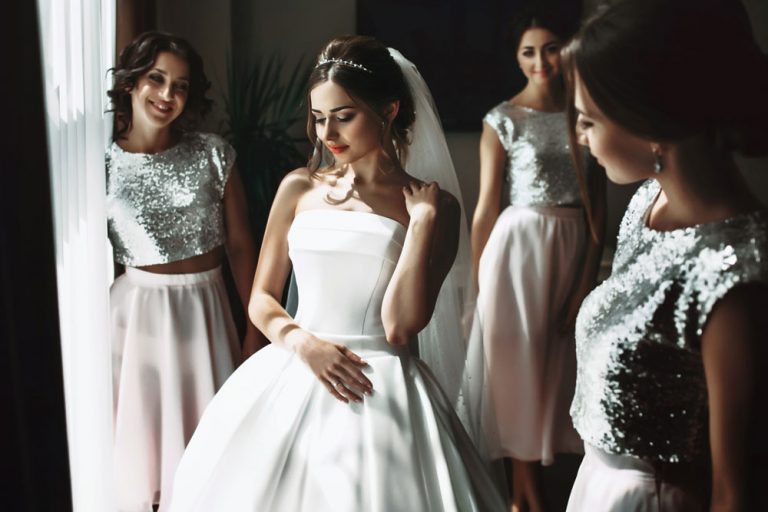 Woman in a wedding dress with bridesmaids