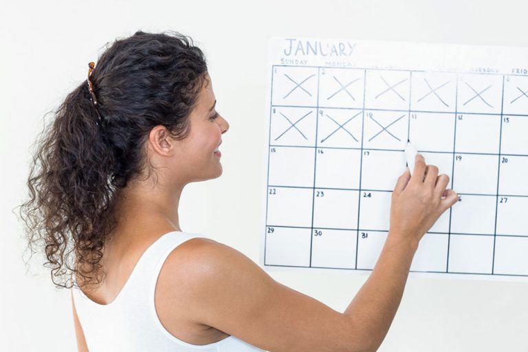 Woman crossing off days on a calendar