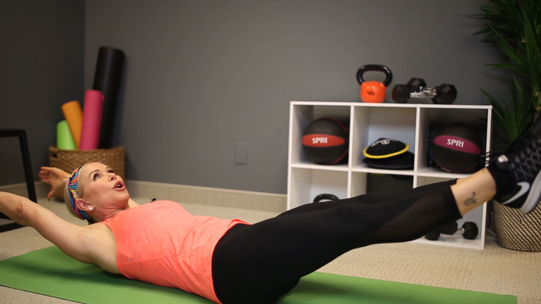 Woman doing a pilates stretch on a yoga mat