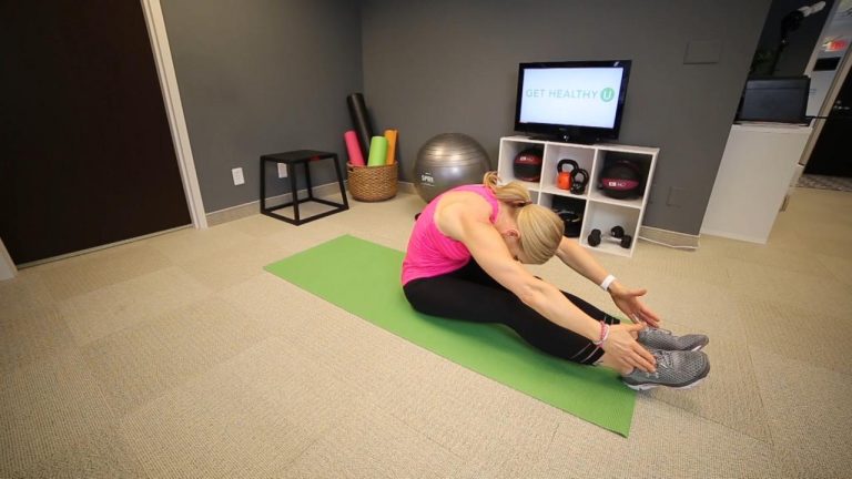 Woman stretching on a green yoga mat