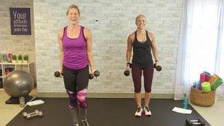 Two women doing a workout with dumbbells
