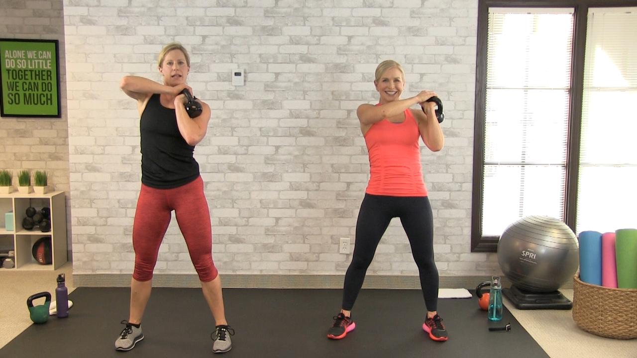 Two women working out with kettlebells