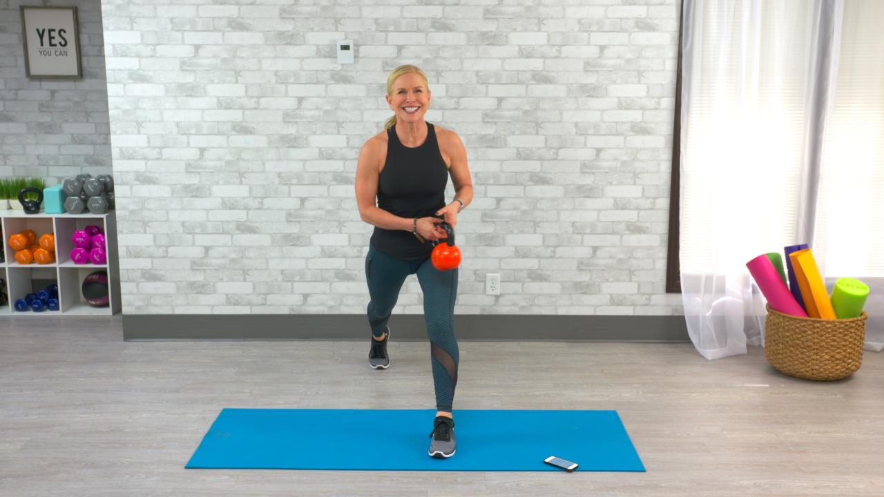 Woman doing a lunge with a kettlebell