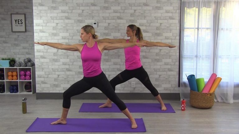 Two women doing warrior yoga pose