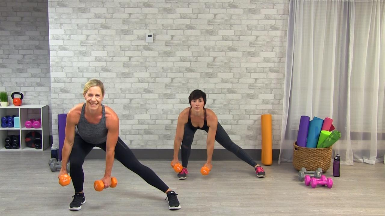 Two women doing lateral lunges with orange dumbbells