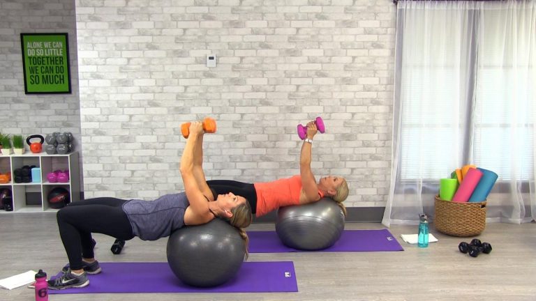 Two women using dumbbells on a stability ball