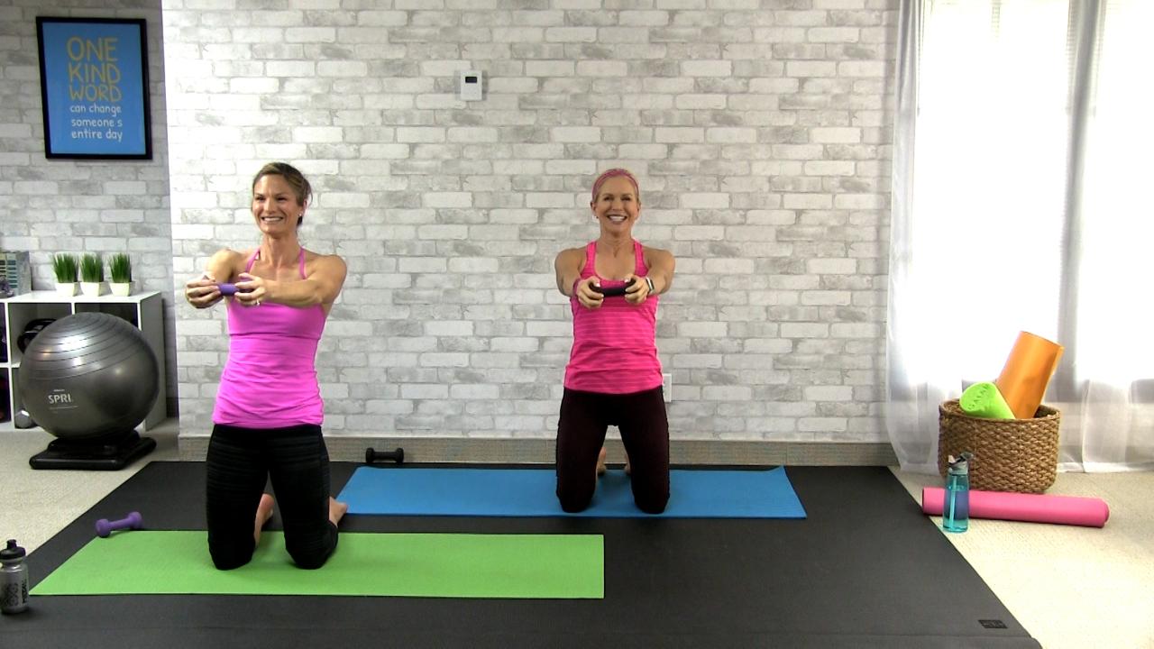 Two women working out with a dumbbell