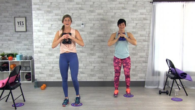 Two women holding dumbbells with gliders