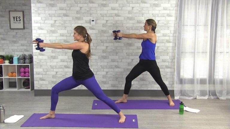 Two women doing yoga with weights
