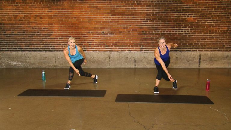 Women doing a workout in front of a brick wall