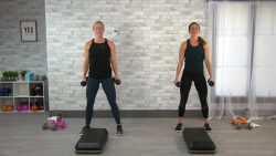 Two women doing a strength step class