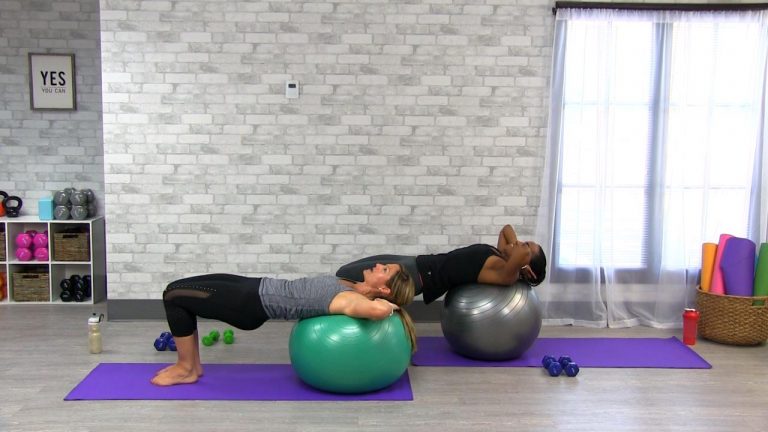Two people doing ab workouts on stability balls