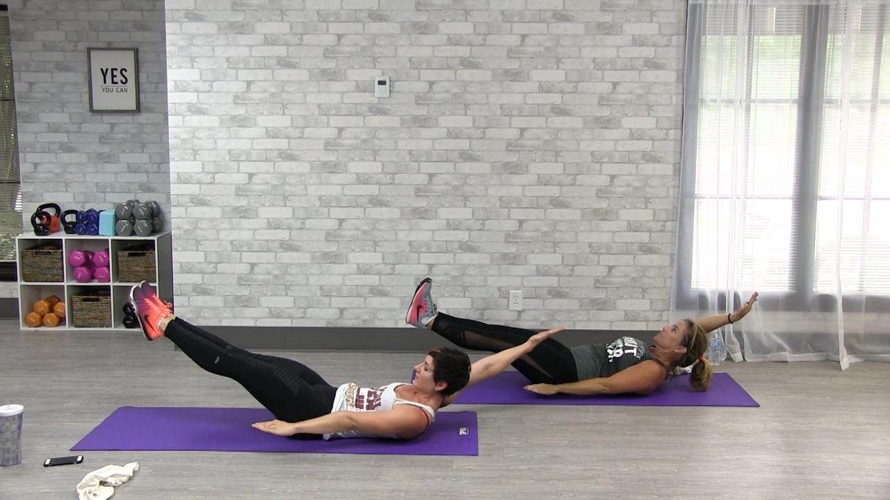 Two women working out on purple exercise mats