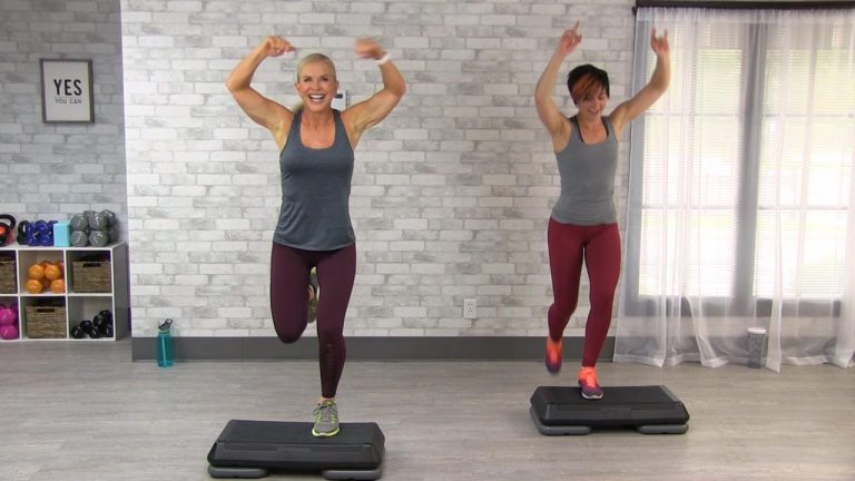 Two women doing a cardio step class