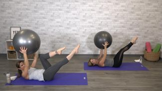 Two women doing pilates with a stability ball