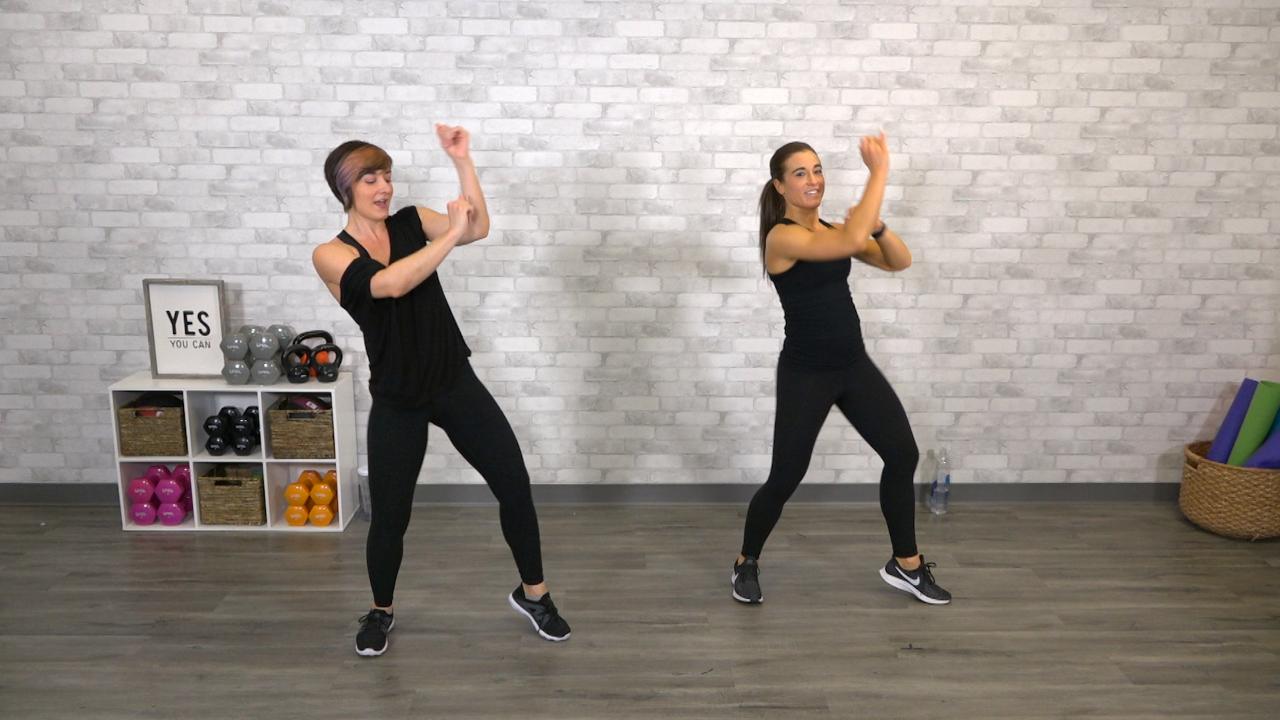 Two women dressed all in black doing dance cardio