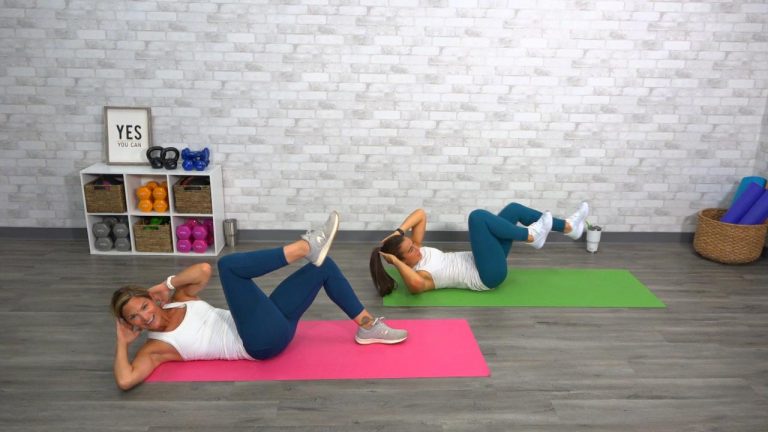 Two women doing a core workout on yoga mats