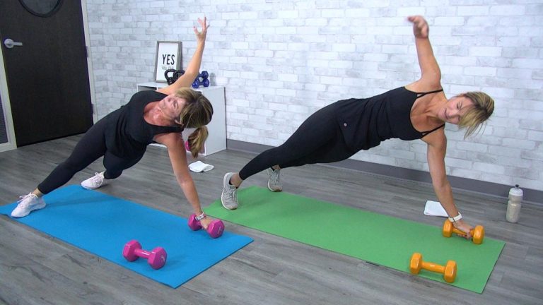 Two women doing side plank reach throughs