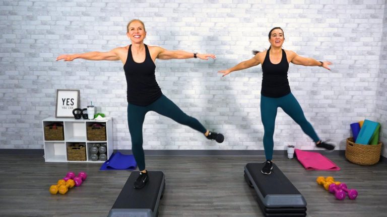 Two women doing a step workout class