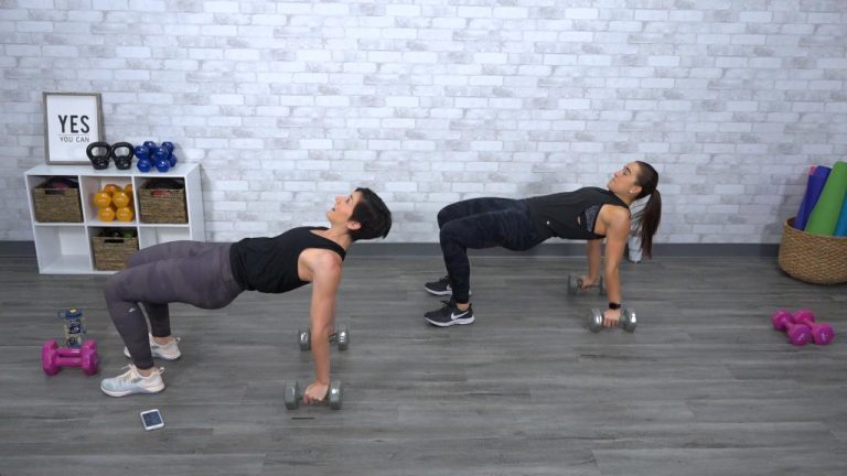 Two women doing a workout with weights