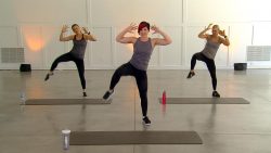Three women doing standing side crunches