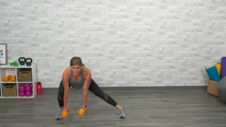 Woman doing a lateral lunge with dumbbells