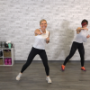 Two women in white tops doing a kickboxing class