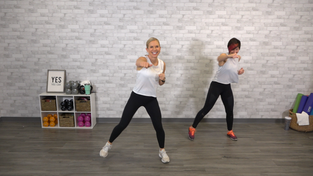Two women in white tops doing a kickboxing class