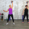 Two women doing one arm overhead presses with kettlebells