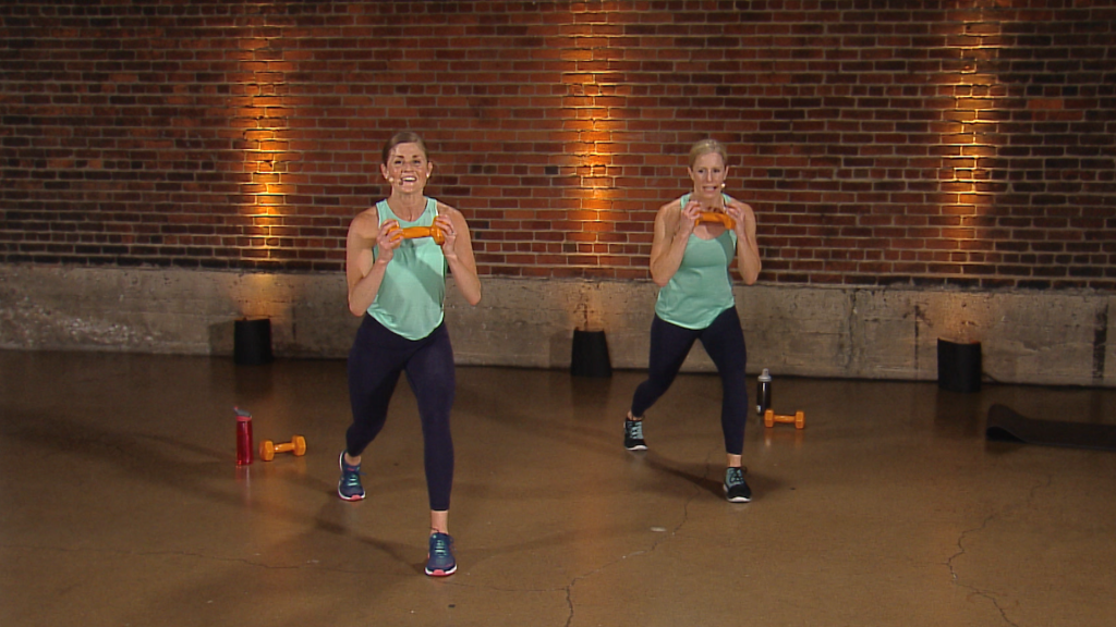Two women working out with orange dumbbells