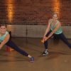 Two women doing side lunges with dumbbells