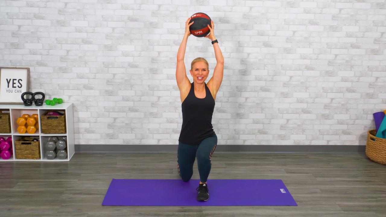 Woman doing a lunge with a medicine ball