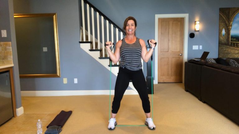 Woman working out with resistance bands in a living room