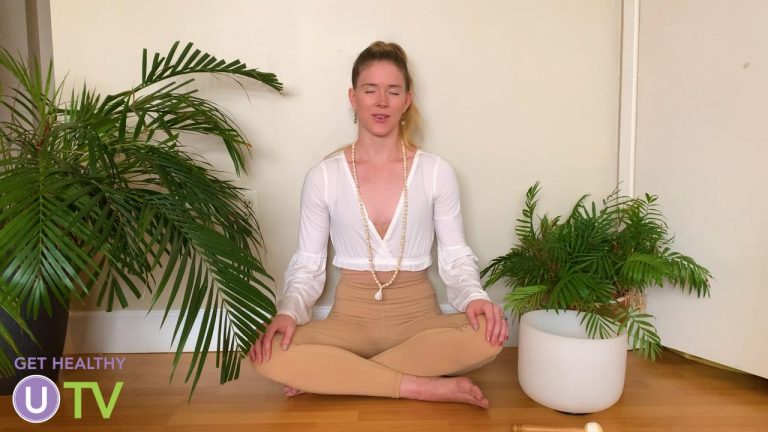 Woman meditating near plants