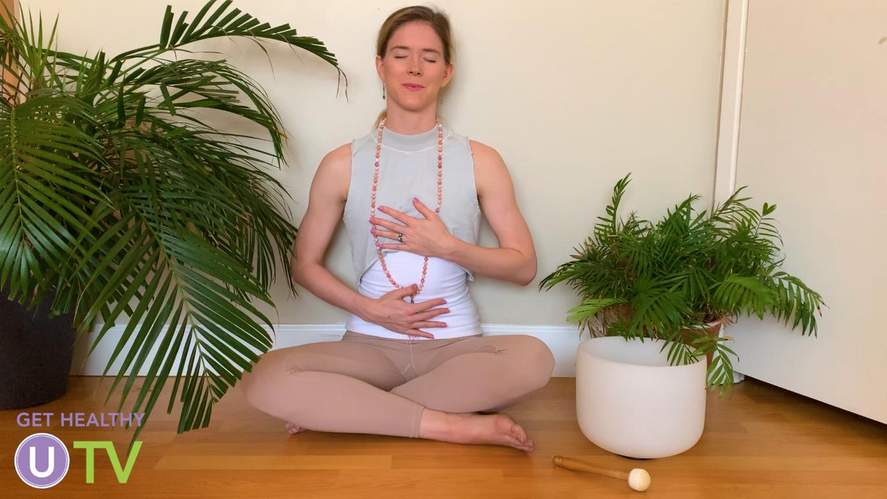 Women with her hands on her chest and belly meditating