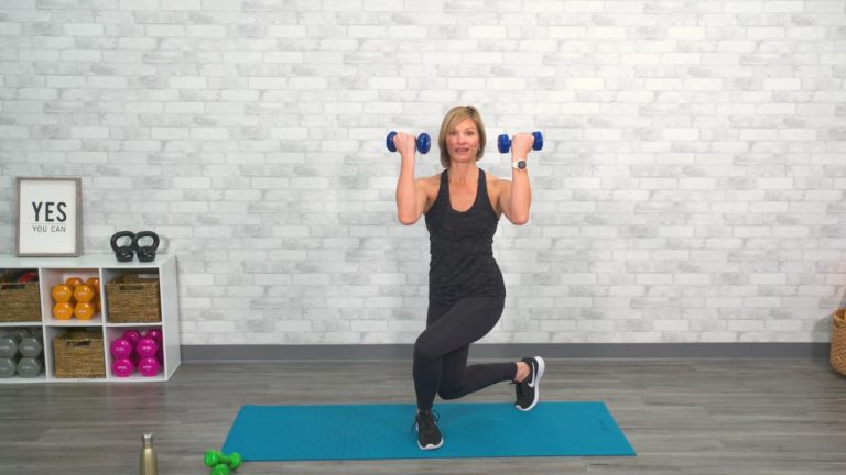 Woman doing a curtsy lunge with dumbbells