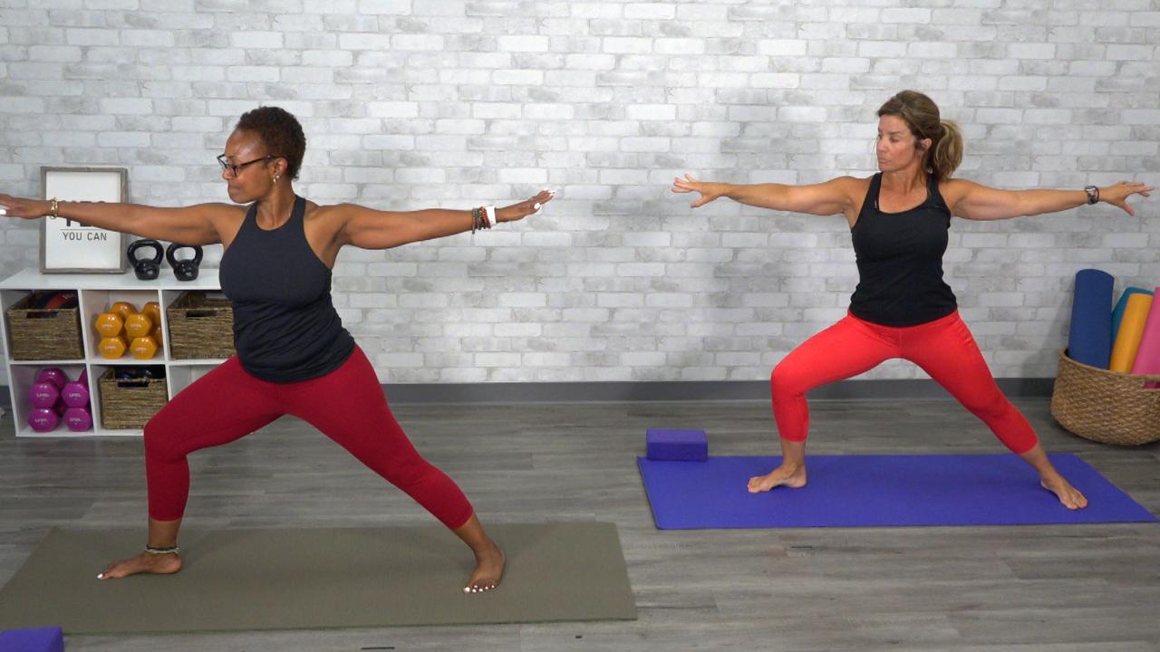 Two women doing a yoga warrior pose