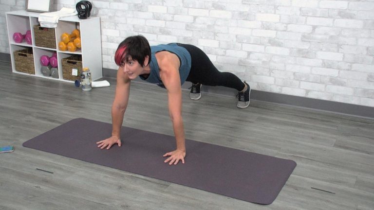 Woman holding a plank on an exercise mat