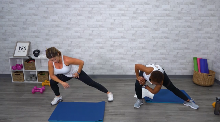 Two women doing a lateral lunge stretch