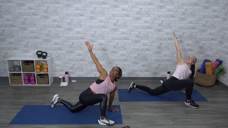 Two women stretching on yoga mats