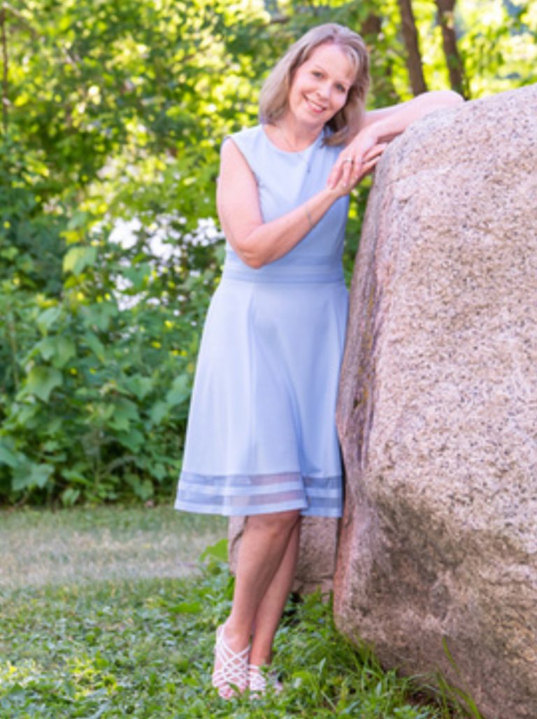 Woman posing against a rock