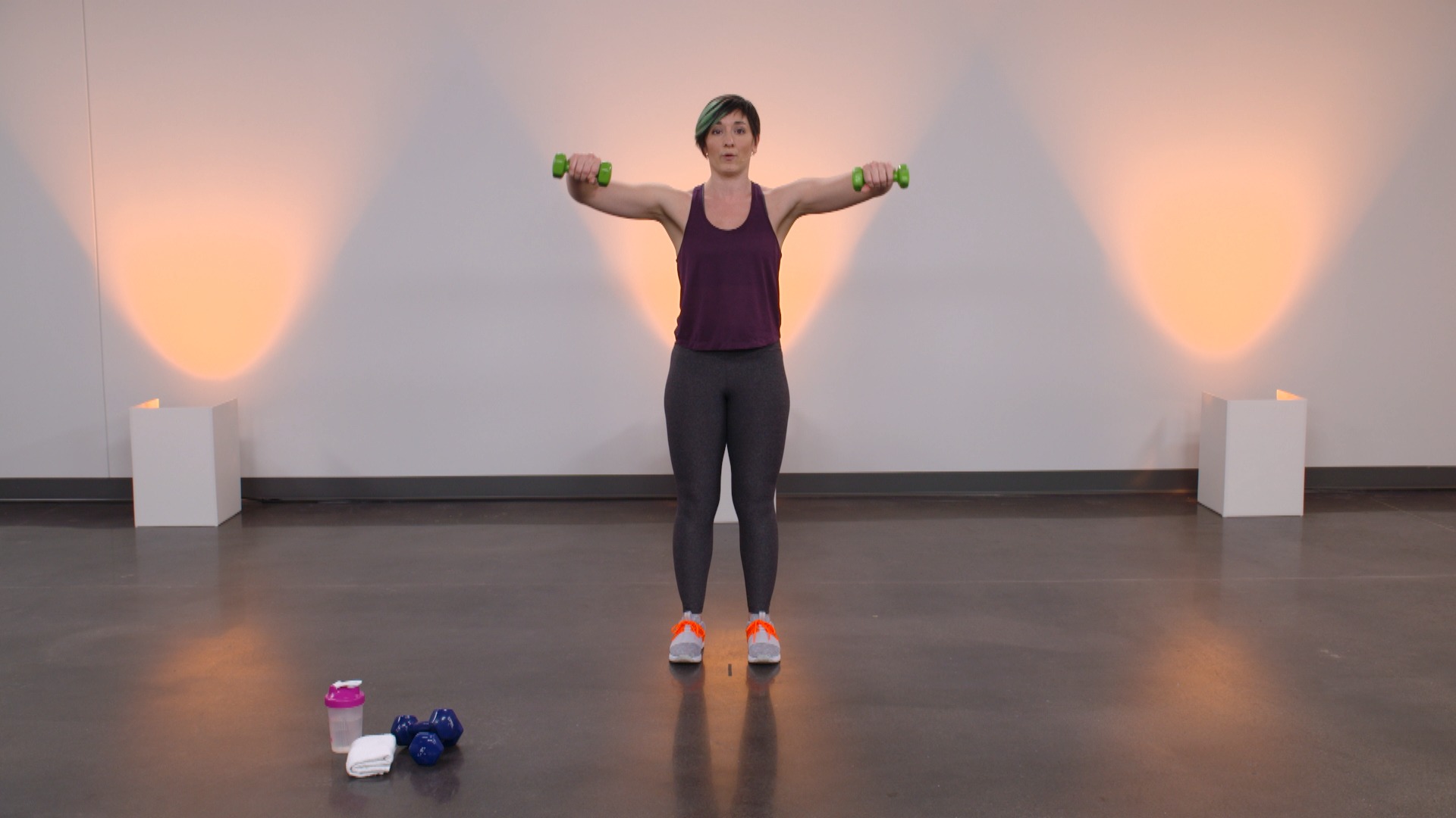 Woman doing an arm raise with dumbbells