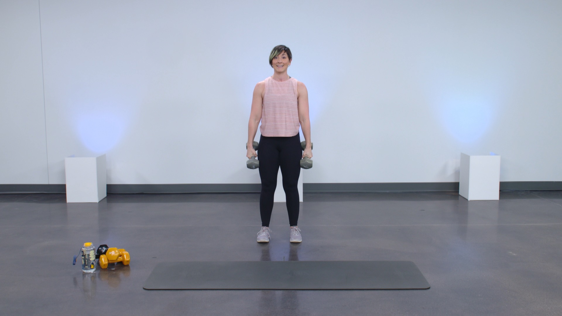 Woman standing with dumbbells