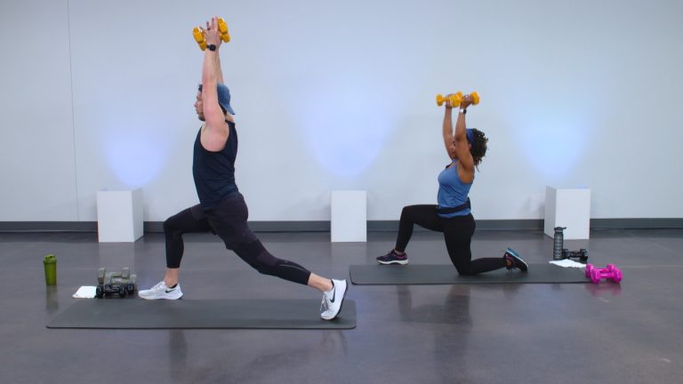 Two people doing lunges with dumbbells overhead