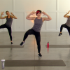 Three women doing standing side crunches