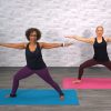 Two women doing a warrior yoga pose
