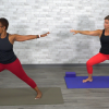 Two women doing a warrior yoga pose