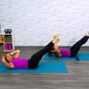 Two women doing an ab workout on blue exercise mats