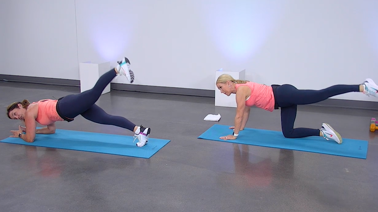 Two women doing plank leg lifts