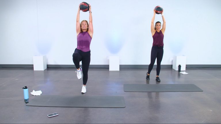 Two women working out with medicine balls